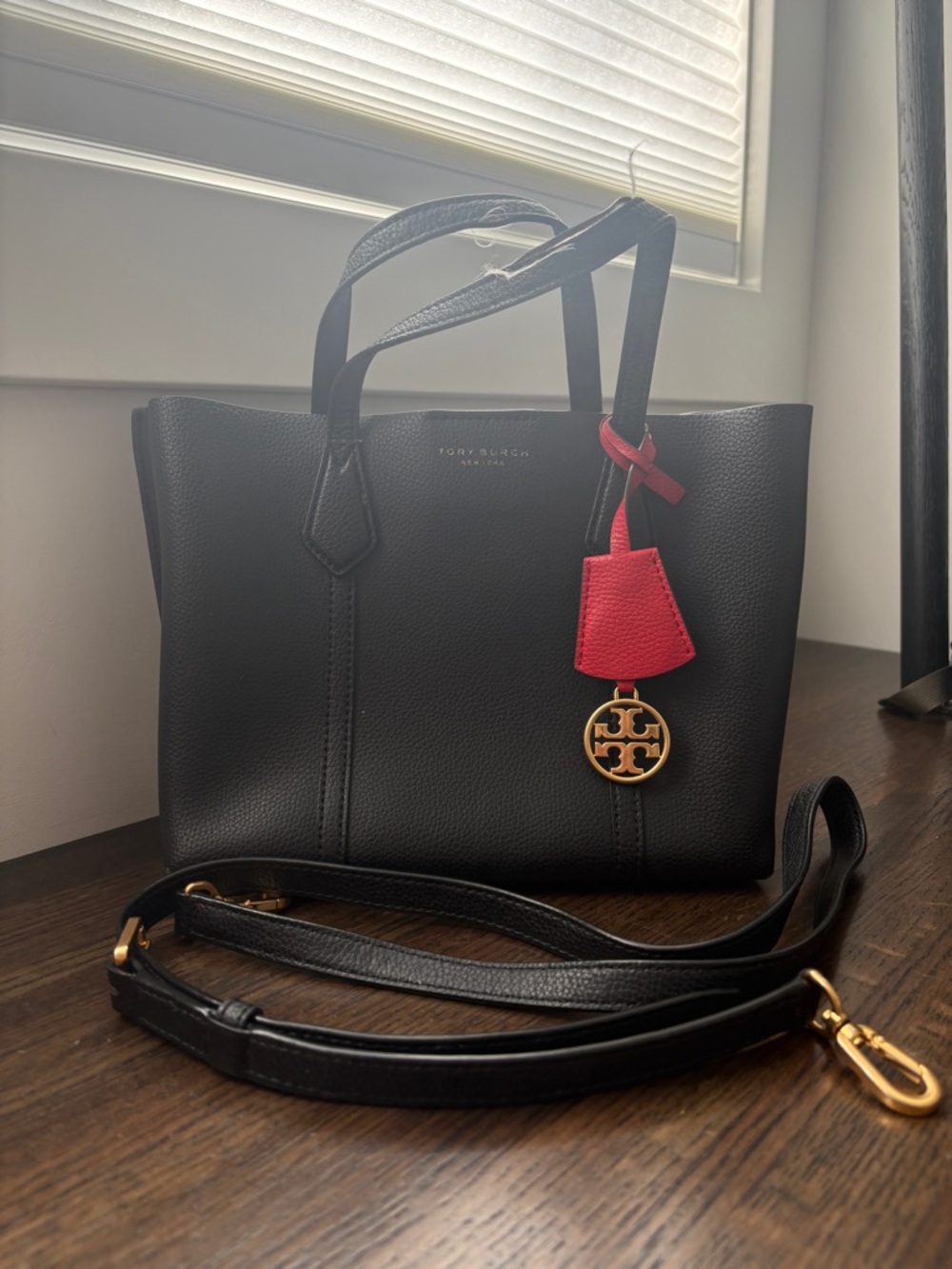 Tory Burch Black Leather Shoulder Tote with Red Charm and Gold Emblem